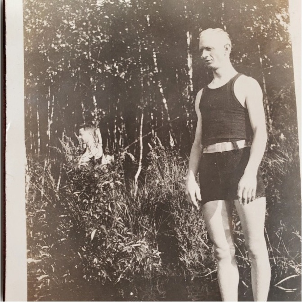 UNIQUE Oddity snapshot photo of a man standing in water, man hiding in brush